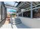 Covered outdoor patio with a bar and grill area perfect for entertaining and enjoying the outdoors at 2202 Donato Dr, Belleair Beach, FL 33786