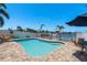 A well-maintained pool with a patio, boat lift and a tranquil waterfront setting at 2202 Donato Dr, Belleair Beach, FL 33786