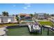 Waterfront homes featuring a boat dock with lift, pool, screened in lanai, and lush landscaping for relaxing outdoor living at 2202 Donato Dr, Belleair Beach, FL 33786