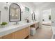 Bathroom showcasing a double vanity with marble countertops and modern fixtures, reflecting a bedroom at 2218 S Occident St, Tampa, FL 33629