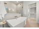 Bright bathroom featuring a modern soaking tub and glass-enclosed shower with a spacious walk-in closet at 2218 S Occident St, Tampa, FL 33629