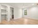 Spacious bedroom showcasing hardwood floors, neutral walls, and closet/bathroom access at 2218 S Occident St, Tampa, FL 33629