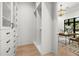 Bright walk-in closet with custom white shelving and drawers, with view into an office space at 2218 S Occident St, Tampa, FL 33629