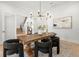 Bright dining room featuring a large wooden table, striking light fixture, and modern chairs at 2218 S Occident St, Tampa, FL 33629