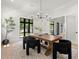 Bright dining room featuring a large wooden table, striking light fixture, and modern chairs at 2218 S Occident St, Tampa, FL 33629