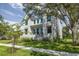 Beautiful two-story modern farmhouse exterior with manicured lawn and mature trees at 2218 S Occident St, Tampa, FL 33629