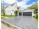 Rear exterior view featuring a large garage and paved driveway, showcasing ample parking at 2218 S Occident St, Tampa, FL 33629