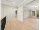 Hallway leading to an open-concept living area with neutral paint and hardwood floors at 2218 S Occident St, Tampa, FL 33629