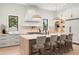Well-lit kitchen with pendant lights, a large island, and sleek stainless steel appliances at 2218 S Occident St, Tampa, FL 33629