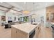 Open concept kitchen with large island, modern lighting, and view to the living space at 2218 S Occident St, Tampa, FL 33629