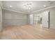 Elegant living room features wall trim, light hardwood floors, and access to a hallway at 2218 S Occident St, Tampa, FL 33629