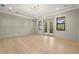 Elegant living room features wall trim, light hardwood floors, and access to a balcony at 2218 S Occident St, Tampa, FL 33629