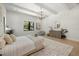 Bright bedroom featuring a comfortable bed, an ensuite bathroom, and hardwood floors at 2218 S Occident St, Tampa, FL 33629