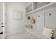 Cozy mudroom with storage bench, decor, and hooks for organization when entering the home at 2218 S Occident St, Tampa, FL 33629
