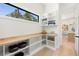 Bright pantry with custom shelving and butcher block countertop, conveniently located near kitchen at 2218 S Occident St, Tampa, FL 33629