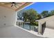 Outdoor patio overlooking the pool with black metal railing and views of lush landscaping at 2218 S Occident St, Tampa, FL 33629