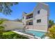 Beautiful in-ground pool with an attached spa surrounded by lush, green landscaping and a large patio at 2218 S Occident St, Tampa, FL 33629
