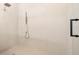 Minimalist shower design featuring a sleek rain shower head and contemporary fixtures against white tile at 2218 S Occident St, Tampa, FL 33629