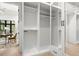 Spacious walk-in closet with custom shelving, mirrored doors, and access to an office space at 2218 S Occident St, Tampa, FL 33629