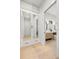 Walk-in closet with mirrored cabinets and drawers, leading to a well-lit bathroom at 2218 S Occident St, Tampa, FL 33629