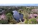 Aerial view of condo community surrounding a pond with a gazebo at 2679 Sabal Springs Cir # 102, Clearwater, FL 33761