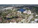 Wide aerial view capturing a neighborhood adjacent to a recreational area with a lake and sports fields at 2679 Sabal Springs Cir # 102, Clearwater, FL 33761