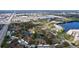 An aerial view of the property showcasing the building, pond, trees, parking, and surrounding neighborhood at 2679 Sabal Springs Cir # 102, Clearwater, FL 33761