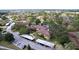 An aerial view of the complex showing the exterior, pond, lush landscaping, and carport parking at 2679 Sabal Springs Cir # 102, Clearwater, FL 33761