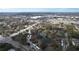 Picturesque aerial view of a residential neighborhood with a tranquil lake and well-maintained roadways at 2679 Sabal Springs Cir # 102, Clearwater, FL 33761