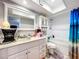 Bright bathroom featuring white vanity, shower-tub combo, and nautical themed decor at 2679 Sabal Springs Cir # 102, Clearwater, FL 33761