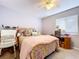 Cozy bedroom featuring a comfortable bed, ceiling fan, and a window letting in natural light at 2679 Sabal Springs Cir # 102, Clearwater, FL 33761