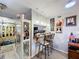 A dining area with a breakfast bar, seating, pendant lighting, and nearby decor at 2679 Sabal Springs Cir # 102, Clearwater, FL 33761