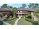 Exterior view of a two story condo community with walkways and lush landscaping at 2679 Sabal Springs Cir # 102, Clearwater, FL 33761