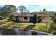 Exterior view of the condo building overlooking a grassy lawn and a pond at 2679 Sabal Springs Cir # 102, Clearwater, FL 33761
