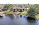 Exterior view from waterfront showcasing building in a lush, landscaped setting at 2679 Sabal Springs Cir # 102, Clearwater, FL 33761