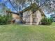 Exterior view of the building showing outdoor patio and landscaping at 2679 Sabal Springs Cir # 102, Clearwater, FL 33761