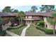 Inviting condo complex with lush landscaping and exterior staircases to the second-story units at 2679 Sabal Springs Cir # 102, Clearwater, FL 33761