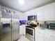 The kitchen comes equipped with stainless appliances, white cabinets, and plentiful counter space at 2679 Sabal Springs Cir # 102, Clearwater, FL 33761