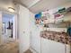 A tidy laundry area with washer, dryer, and shelving for organized storage at 2679 Sabal Springs Cir # 102, Clearwater, FL 33761