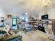 Open-concept living room featuring a sofa, glass coffee table, and a TV on a shelf at 2679 Sabal Springs Cir # 102, Clearwater, FL 33761