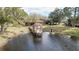 Scenic view of a beautiful pond with a charming gazebo extending onto the water, surrounded by lush greenery at 2679 Sabal Springs Cir # 102, Clearwater, FL 33761