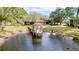 View of pond with wooden deck and gazebo for residents to enjoy at 2679 Sabal Springs Cir # 102, Clearwater, FL 33761