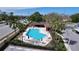 Aerial view of a community swimming pool, lounge chairs and landscaping at 2679 Sabal Springs Cir # 102, Clearwater, FL 33761
