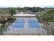 Aerial view of pristine blue tennis courts with green fencing, ready for a match in a beautiful setting at 2679 Sabal Springs Cir # 102, Clearwater, FL 33761