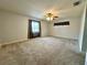 A large main bedroom is complete with plush carpeting, a ceiling fan, and a bright window at 2820 Pankaw Ln, Valrico, FL 33596