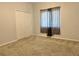 A cozy bedroom features neutral carpet, a window with coverings, a ceiling fan, and a double door closet at 2820 Pankaw Ln, Valrico, FL 33596