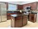 Kitchen features stainless steel appliances, tile floors, granite counters, and dark wood cabinets at 2820 Pankaw Ln, Valrico, FL 33596