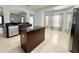Modern kitchen featuring an island, stainless steel appliances, and tile flooring at 2820 Pankaw Ln, Valrico, FL 33596