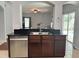 Kitchen area featuring a stainless steel dishwasher and sink and dark wood cabinets at 2820 Pankaw Ln, Valrico, FL 33596