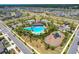 An aerial view of a community featuring a pool, clubhouse, and playground at 3078 Marine Grass Dr, Wimauma, FL 33598